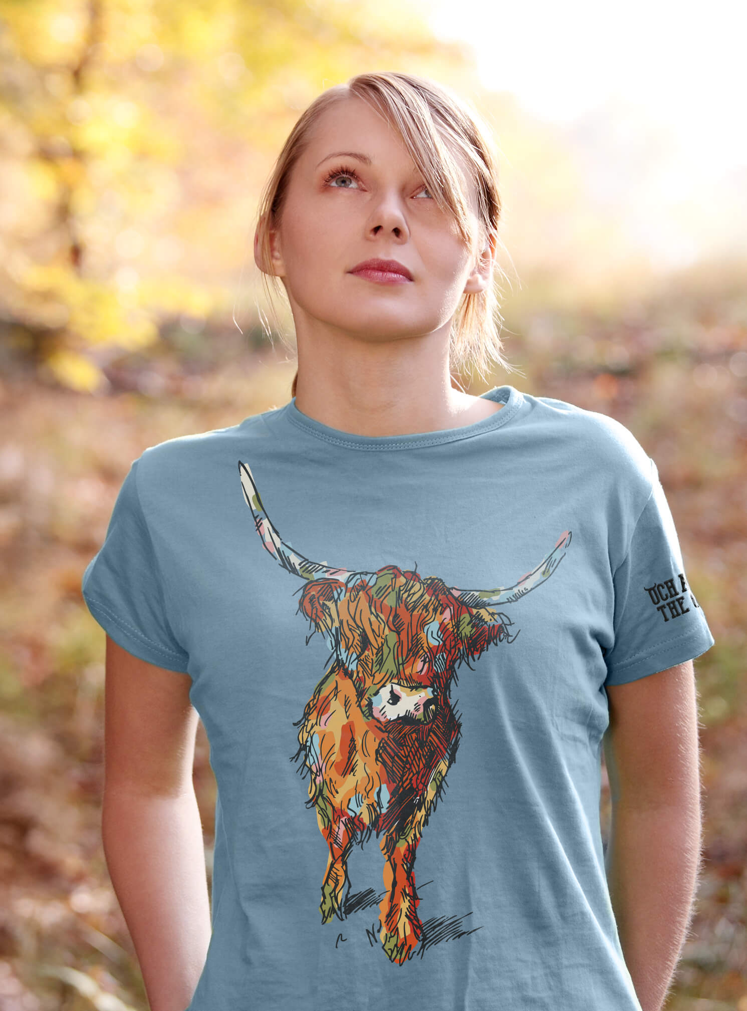 Young woman wearing light blue t-shirt from our Colourful Coo collection