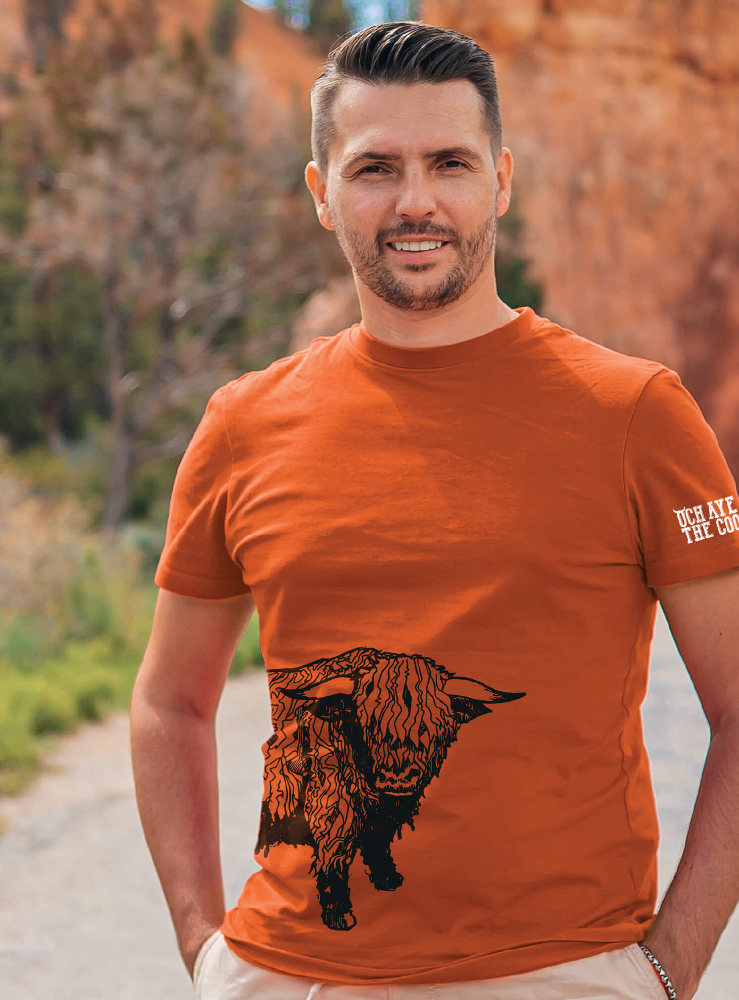 Man wearing orange t-shirt from our Coos The Noo collection